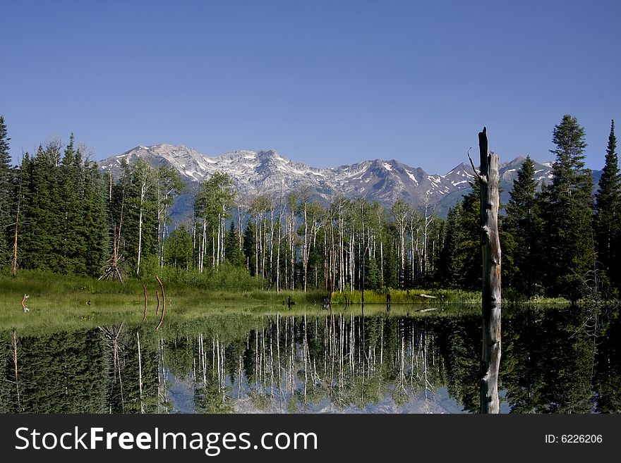 High mountain lake in the spring showing colors reflected in the water. High mountain lake in the spring showing colors reflected in the water