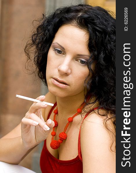 Closeup portrait of pretty brunette with cigarette