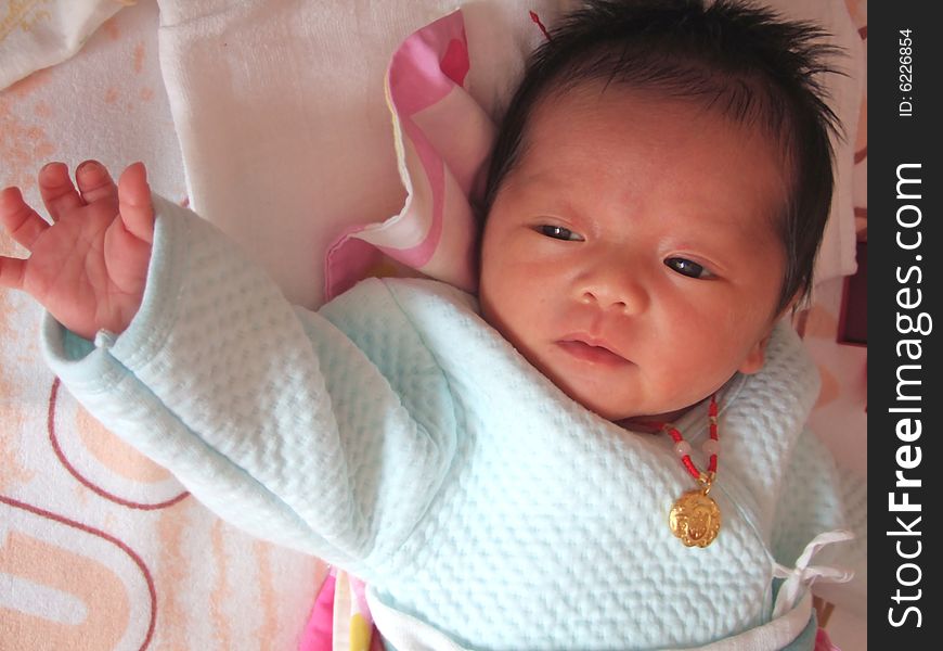 Infant and accessories on a bed