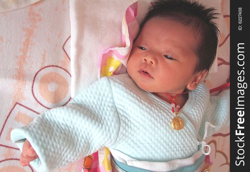 Infant and accessories on a bed