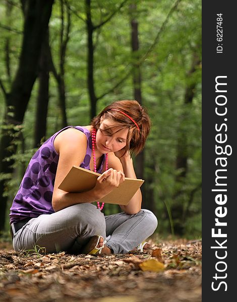 Beautiful student holding the book in her hands. Beautiful student holding the book in her hands.