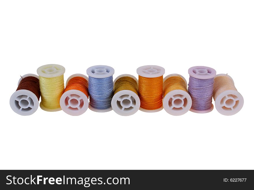 Line of colorful threads isolated on white background