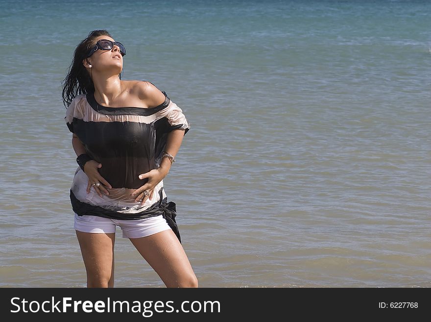 Woman in the seaside with wet clothes