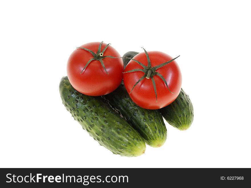 Tomatoes and cucumbers isolated on white background