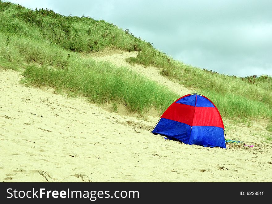 View of a tent on a beach in Wales. View of a tent on a beach in Wales.