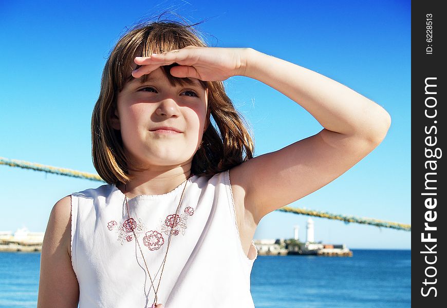 Girl in a port. Looking into the distance