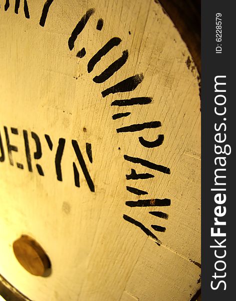 Close-up view on a barrel in a whisky distillery. Close-up view on a barrel in a whisky distillery.