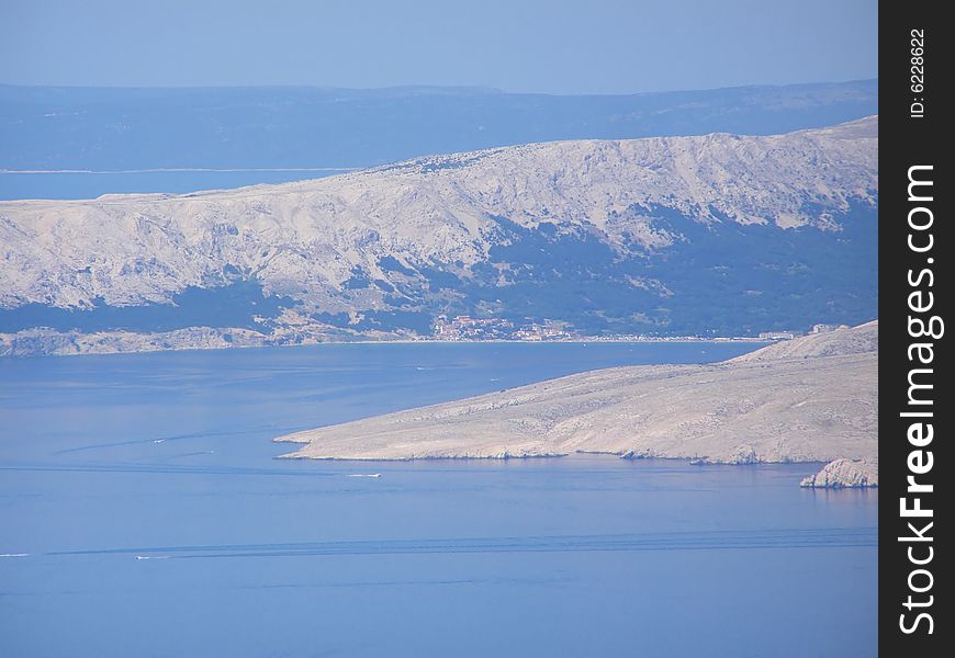 Croatia - view from the Velebit Mountain (Vratnik Pass) to the Adriatic Sea and Kvarner Bay - islands of Krk and Cres in the background. Croatia - view from the Velebit Mountain (Vratnik Pass) to the Adriatic Sea and Kvarner Bay - islands of Krk and Cres in the background