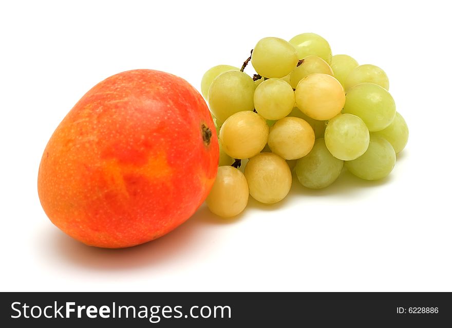 Green grape and mango isolated on white