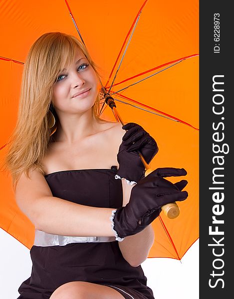 The young beautiful girl under an orange umbrella in a black dress and in gloves isolated on white. The young beautiful girl under an orange umbrella in a black dress and in gloves isolated on white
