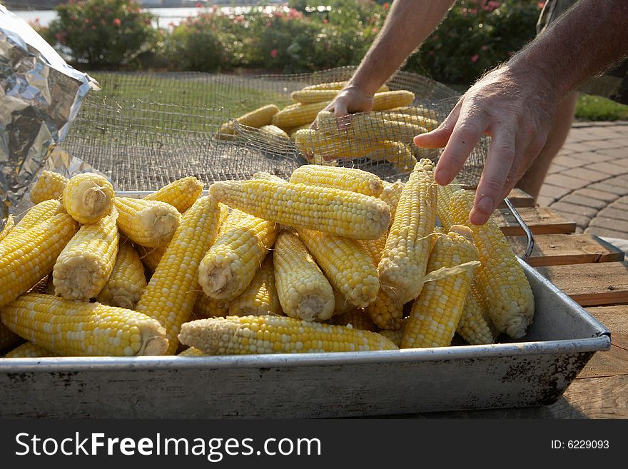 Closeup of preparation of corn on the cob at barbecue