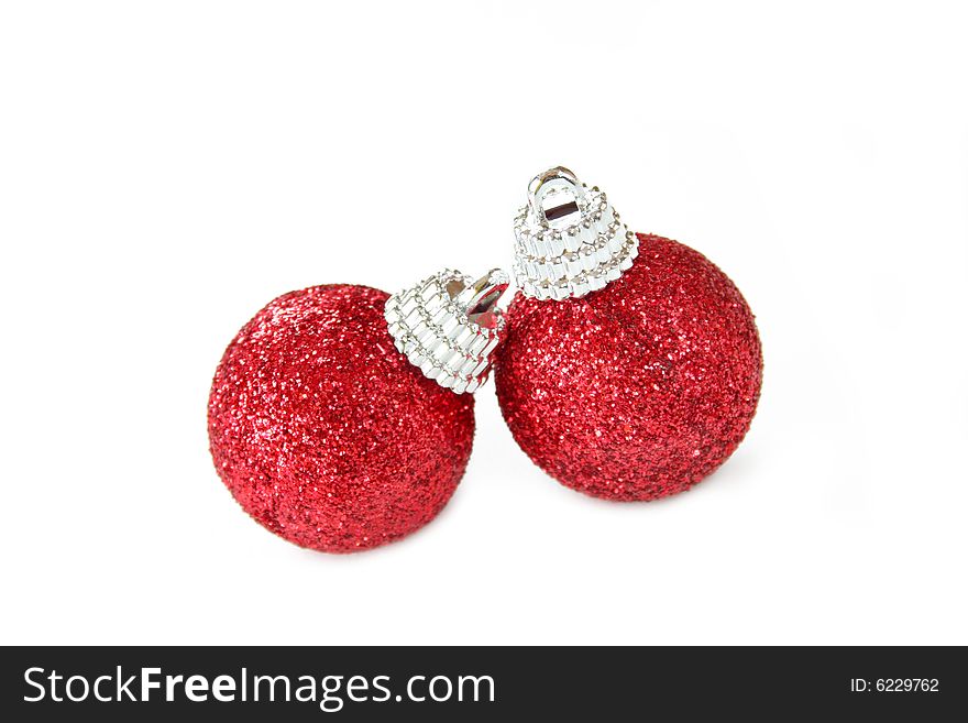 Two red Christmas ornaments made of glitter and isolated on a white background.