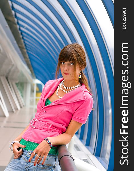 Young beautiful girl standing by the rail. Young beautiful girl standing by the rail