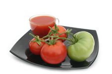 Green Tomato On A Black Plate Royalty Free Stock Images