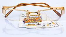 Golden Frame Reading Glass On 3 Used Playing Cards Royalty Free Stock Photography Golden Frame Reading Glass On 3 Used Playing Cards Royalty Free Stock Photography