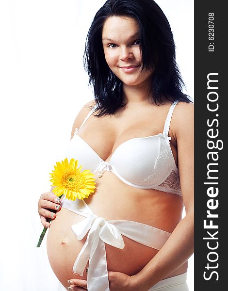 Young pregnant woman with flower. Young pregnant woman with flower.