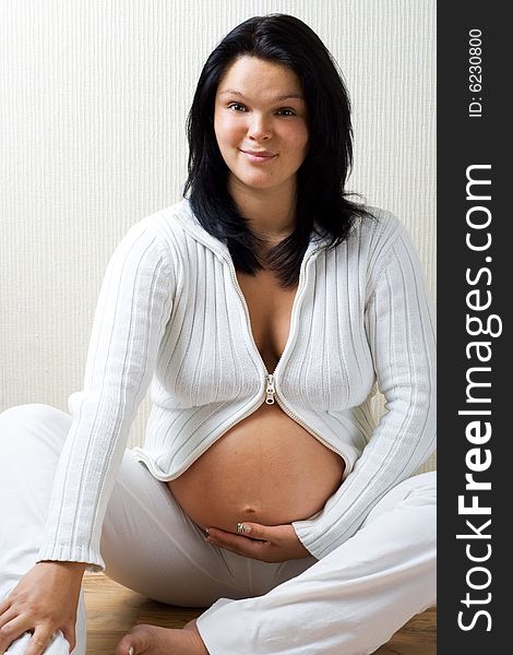 Young pregnant woman looking at camera. Young pregnant woman looking at camera.