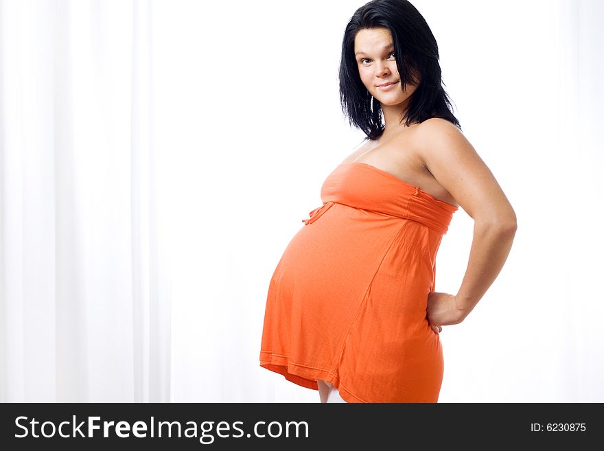 Young pregnant woman looking at camera. Young pregnant woman looking at camera.