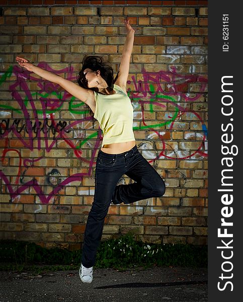 Young girl dancing against the wall. Young girl dancing against the wall.