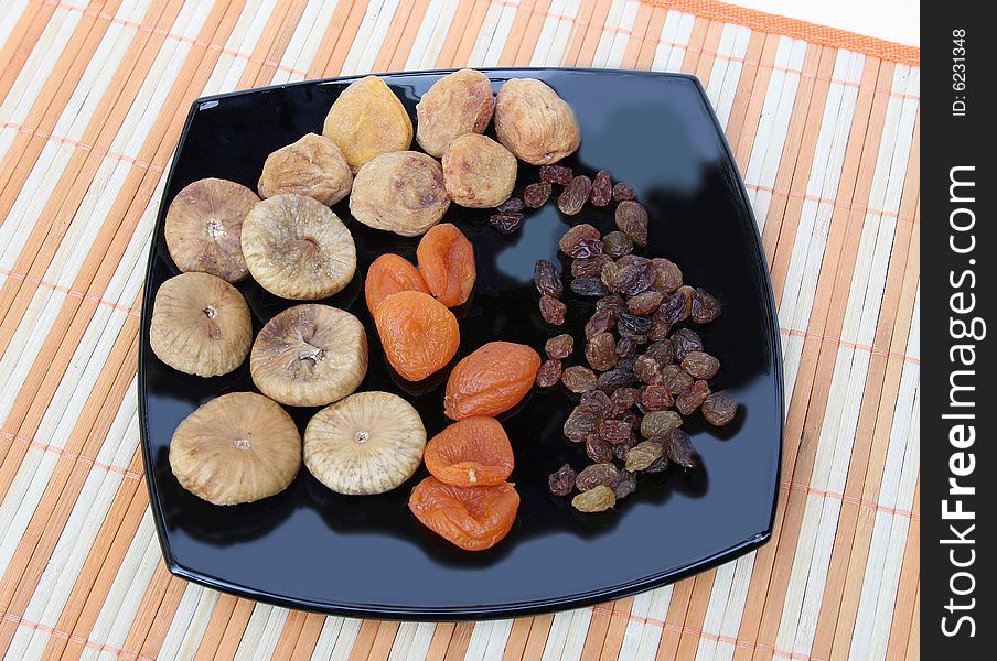 Fruit for compote on a white background with an orange striped napkin