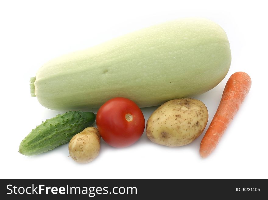 Vegetable marrow and other vegetables on a white background