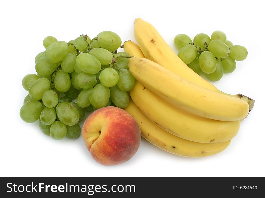 Yellow bananas and green grapes with a peach on 
a white background