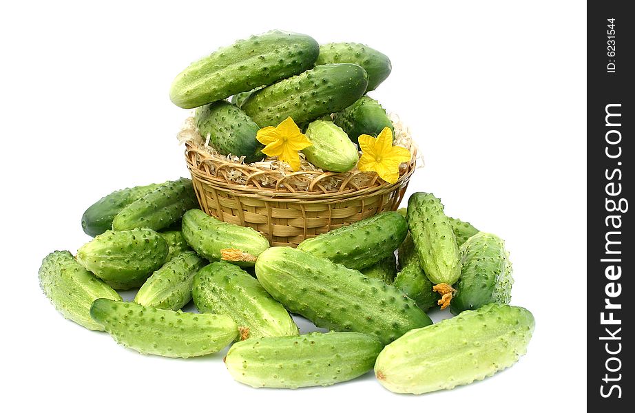 Green cucumbers in a yellow wum basket