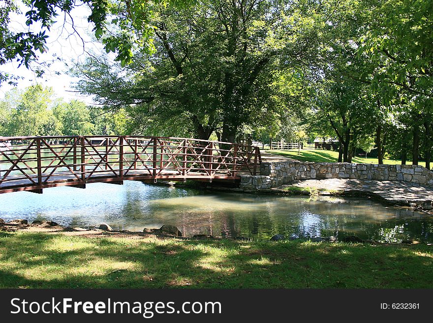 Pretty scene in a park in Virginia with a brook and a bridge. Pretty scene in a park in Virginia with a brook and a bridge.