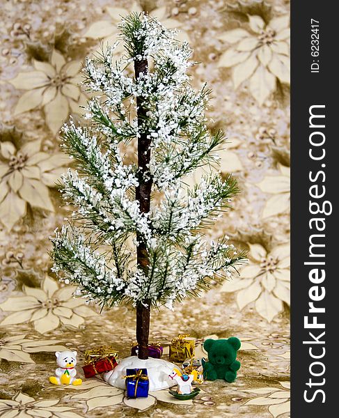 Evergreen tree with white snow. Presents and toys underneath. White/gold poinsettia flower background. Evergreen tree with white snow. Presents and toys underneath. White/gold poinsettia flower background.