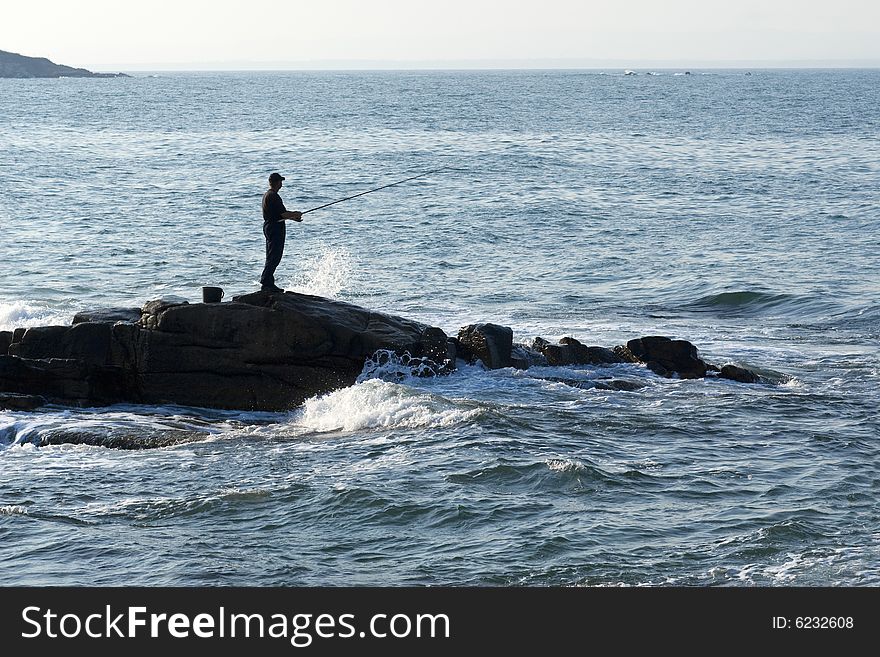 A man is fushing in a nice sunny day. A man is fushing in a nice sunny day