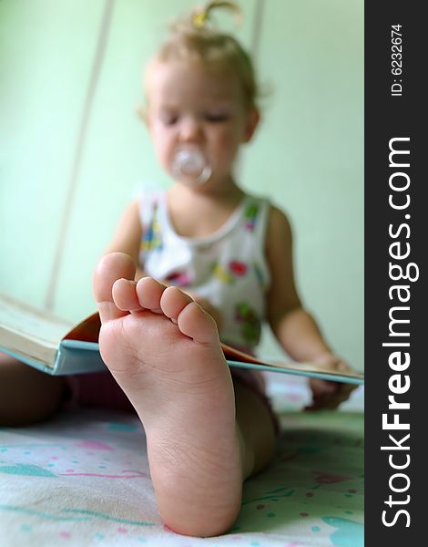 An image of reading baby. Foot closeup. An image of reading baby. Foot closeup