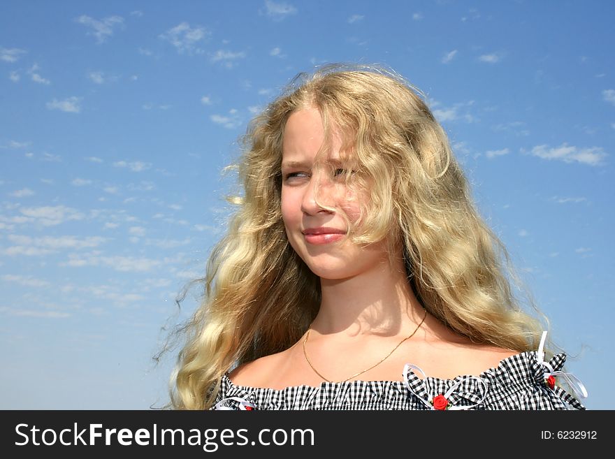 Pretty blond girl with long hair on the sky background. Pretty blond girl with long hair on the sky background.