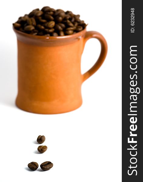 Roasted coffee and cup, white background. Roasted coffee and cup, white background.