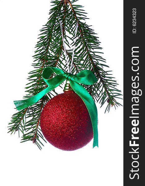 Red ball on fir branch with ribbons and bow isolated on white