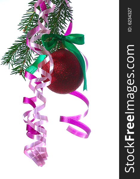 Red ball on fir branch with ribbons and bow isolated on white
