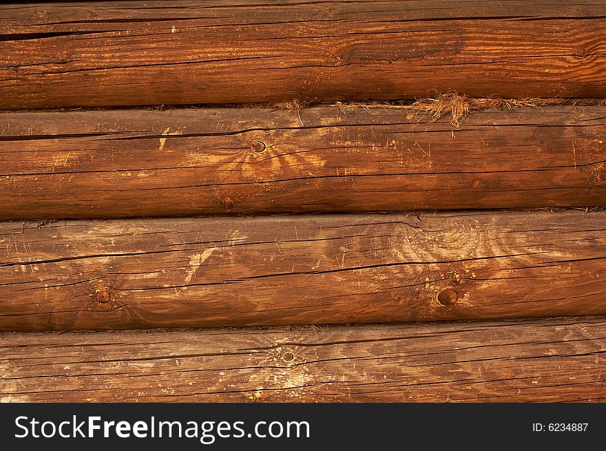 Wall of a hut from a round log