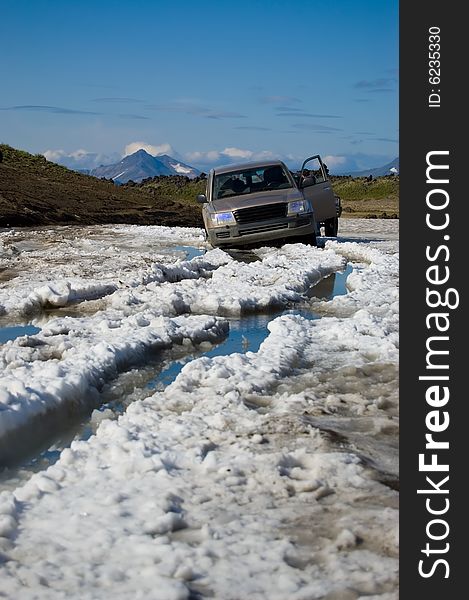 Allroad car overcome a snowfield in Kamchatka.