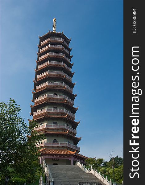 A very tall chinese style pagoda with octagonal shape