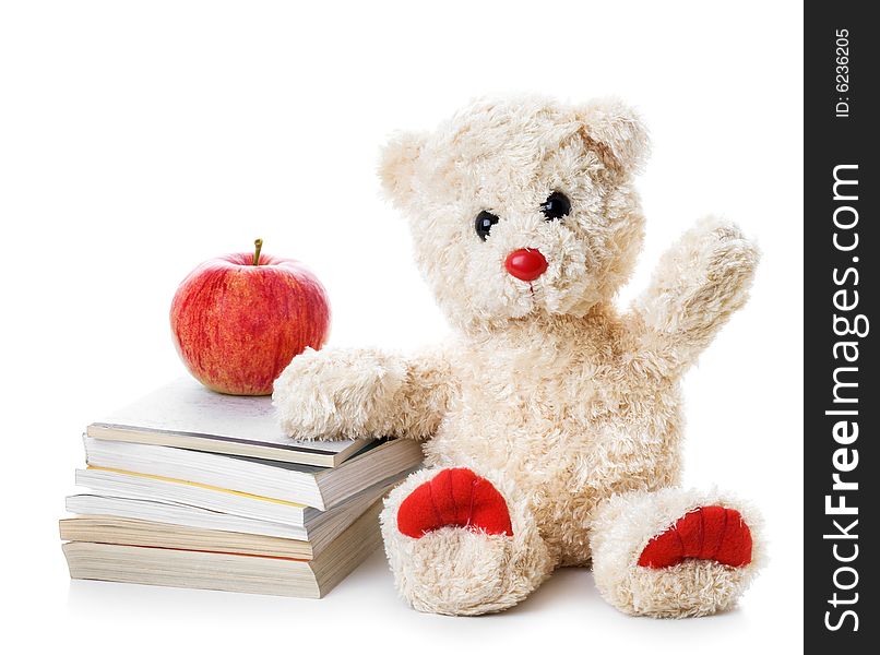 Teddy bear with a heap of books and an apple. Teddy bear with a heap of books and an apple