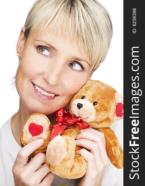 Young blond girl with teddy bear close up