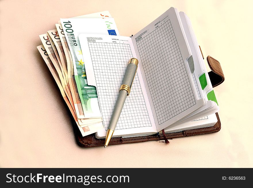 Leather organizer with pen and a banknotes. Leather organizer with pen and a banknotes