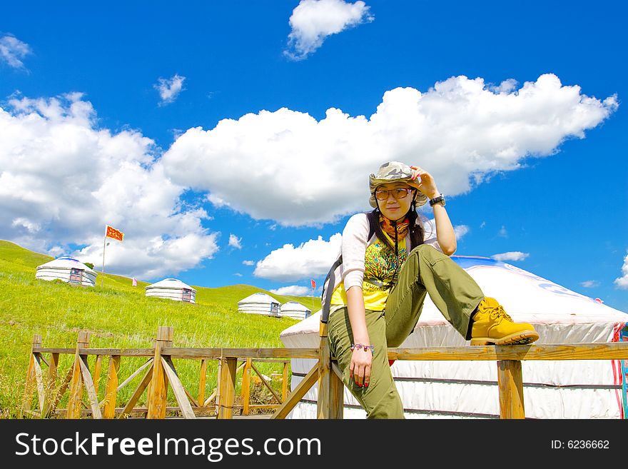 Happy girl on meadow against the blue sky and clouds. Happy girl on meadow against the blue sky and clouds