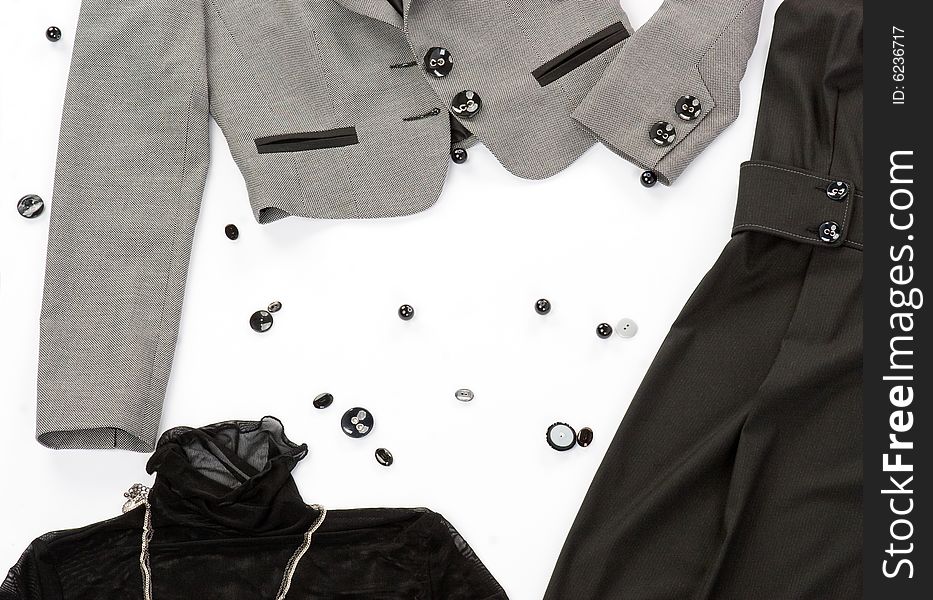 Black buttons with clothes over white background