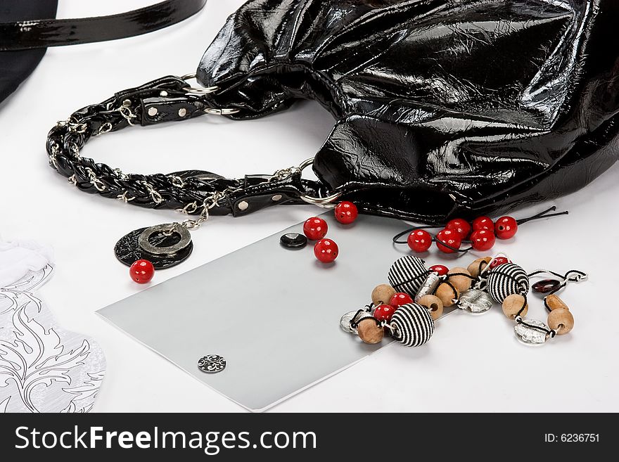 Black bag with color beads over white background