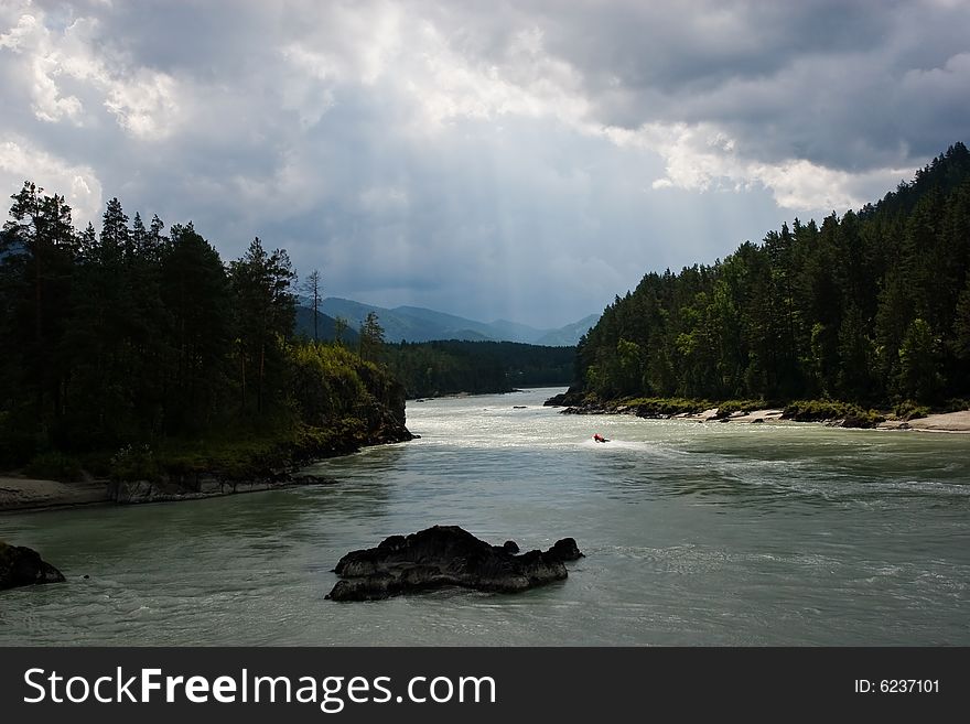 River light up by sunbeam through storm sky. River light up by sunbeam through storm sky