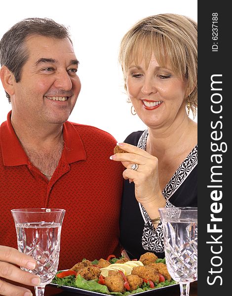 Couple having appetizers isolated on white