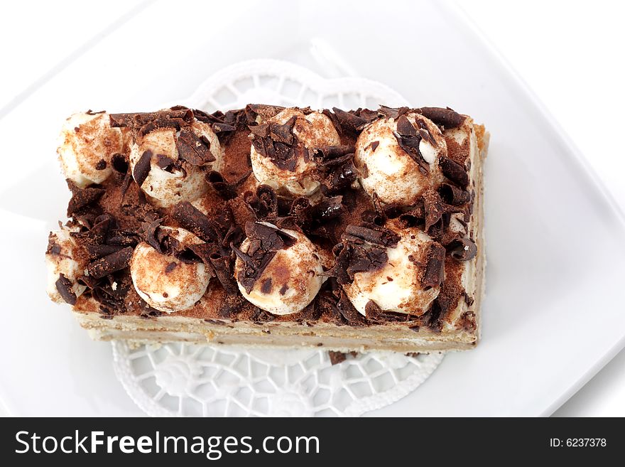 Chocolate Cake on a Plate Isolated on White Background. Chocolate Cake on a Plate Isolated on White Background