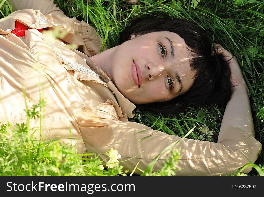 The beautiful young brunette in park