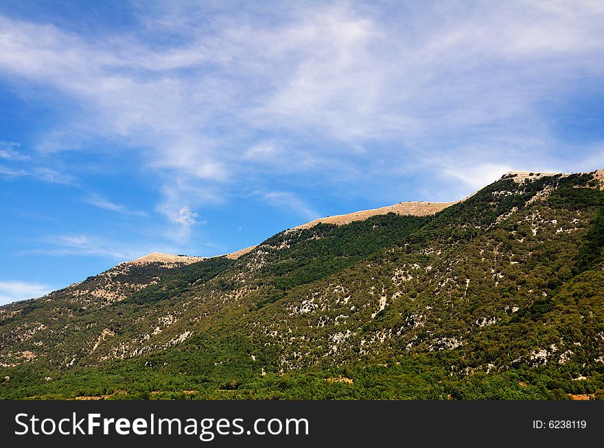 An abruzzo mountain in central italy, in a bright hot summer morning with cirrus clouds. An abruzzo mountain in central italy, in a bright hot summer morning with cirrus clouds