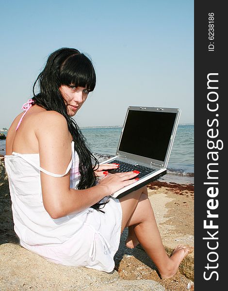 Girl on a beach with a notebook